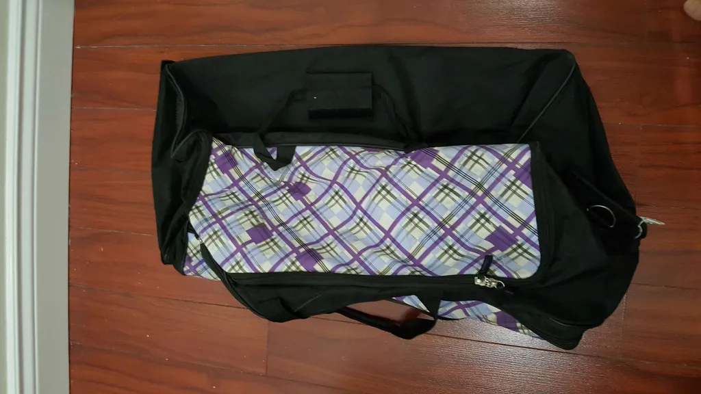 large wheeled duffel bag -- sturdy AF -- small hole in fabric... photo 1