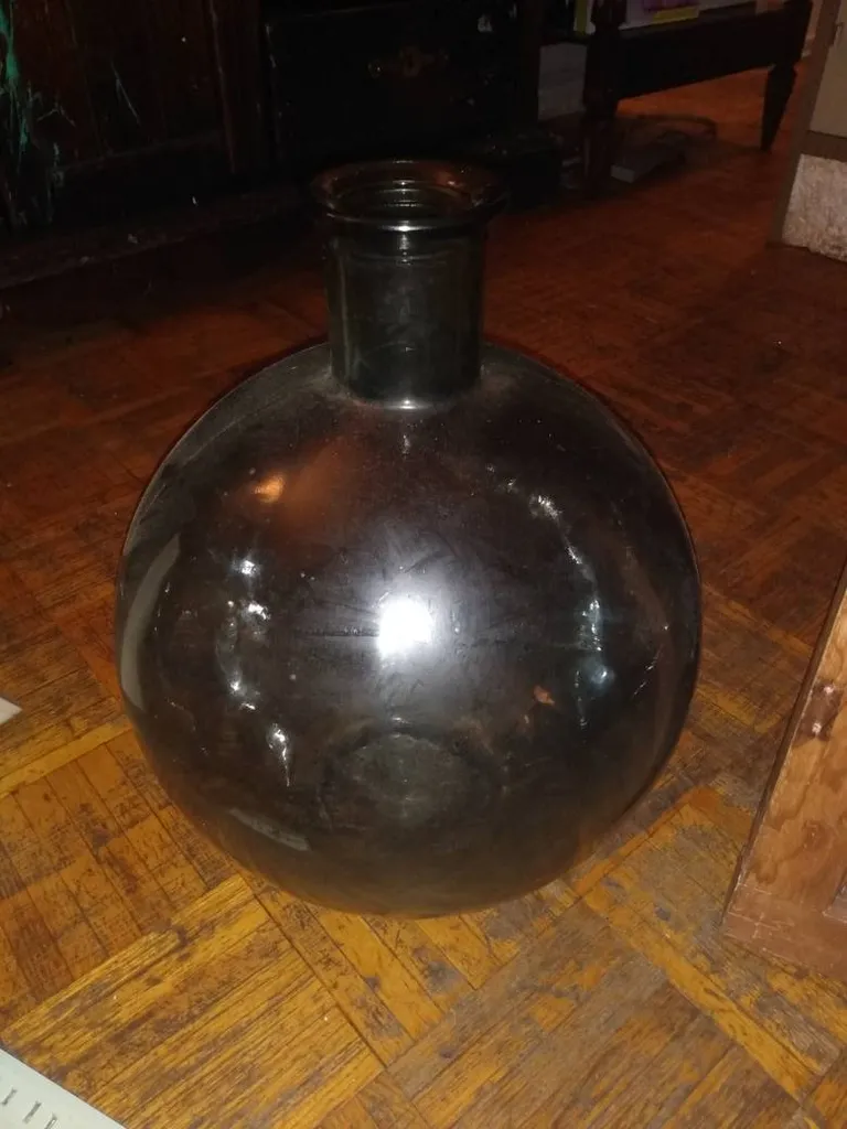 An Old Glass Bottle Bigger Than A Basketball photo 1