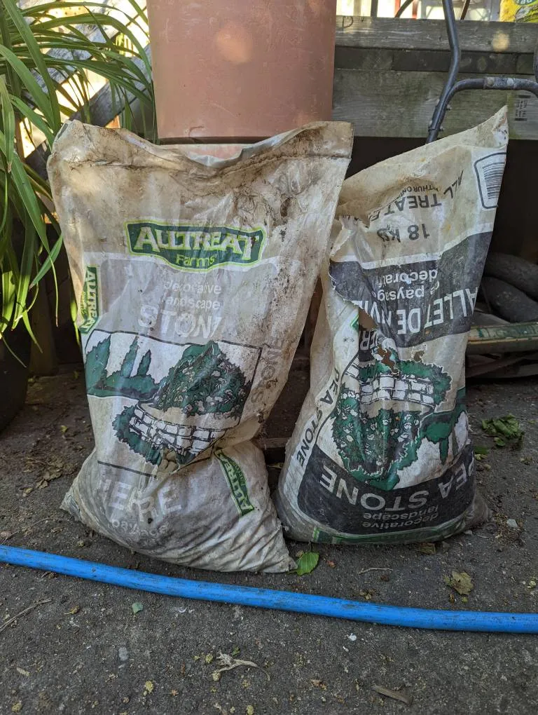 1/3 bag of decorative stone and 3/4 bag of pea stone photo 1