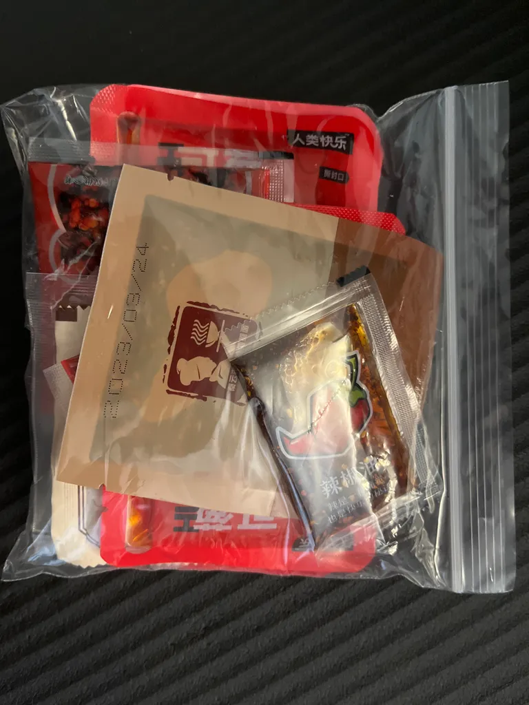 FREE - A variety of chili oil packs and some spicy tofu snack photo 1