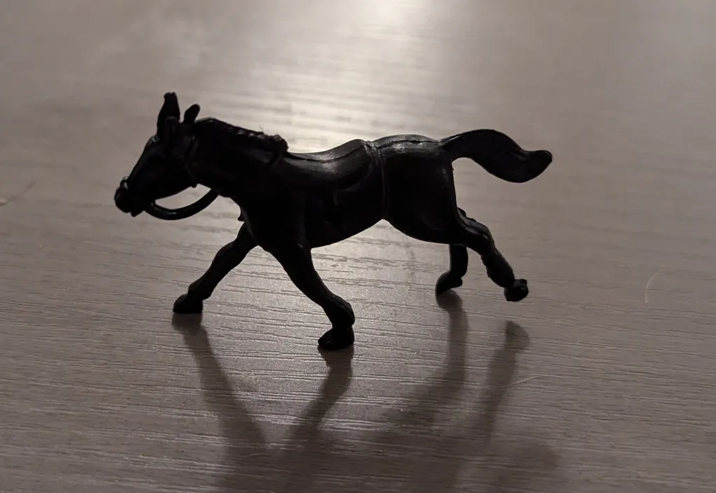 Black plastic toy horse photo 1