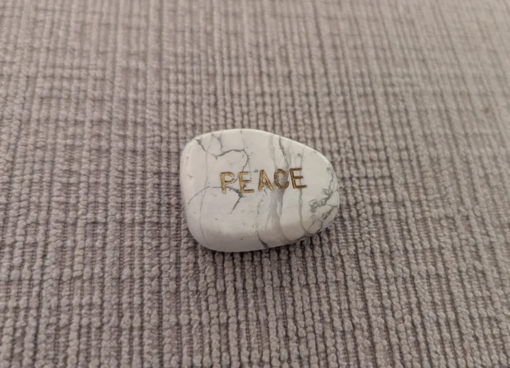 White Howlite Stone with 'Peace' inscription photo 1
