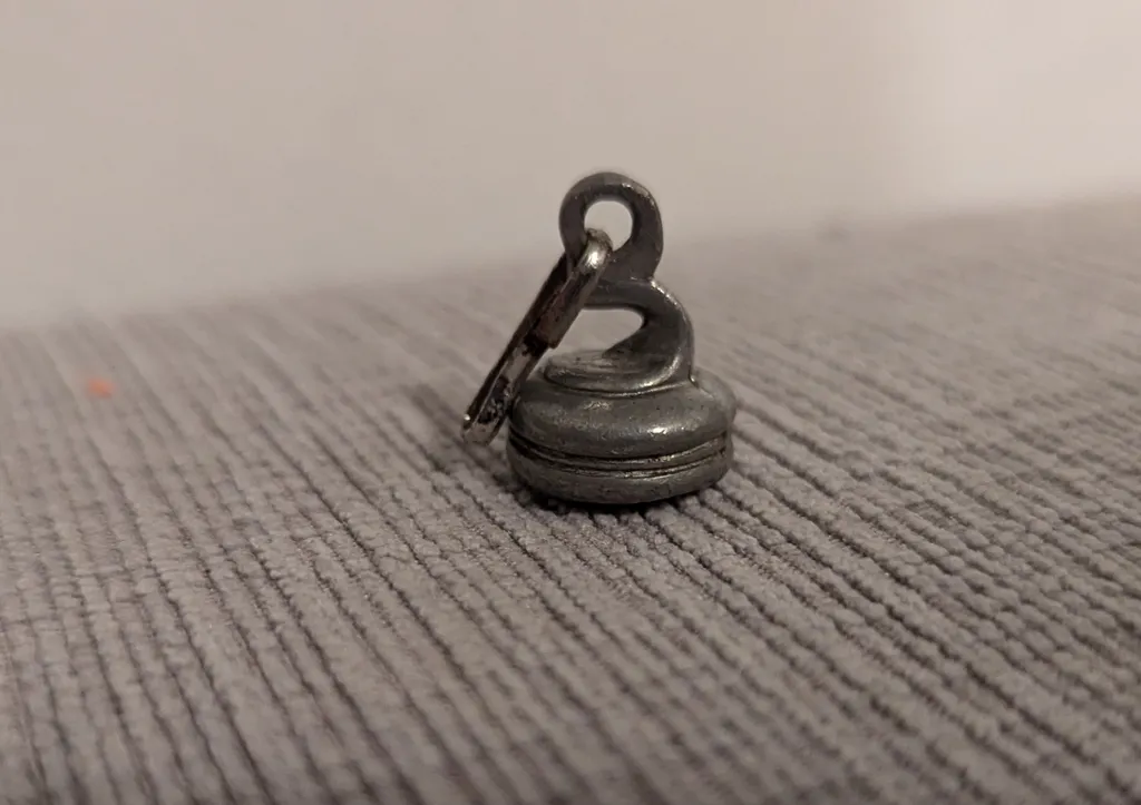 Silver Curling Stone Charm photo 1