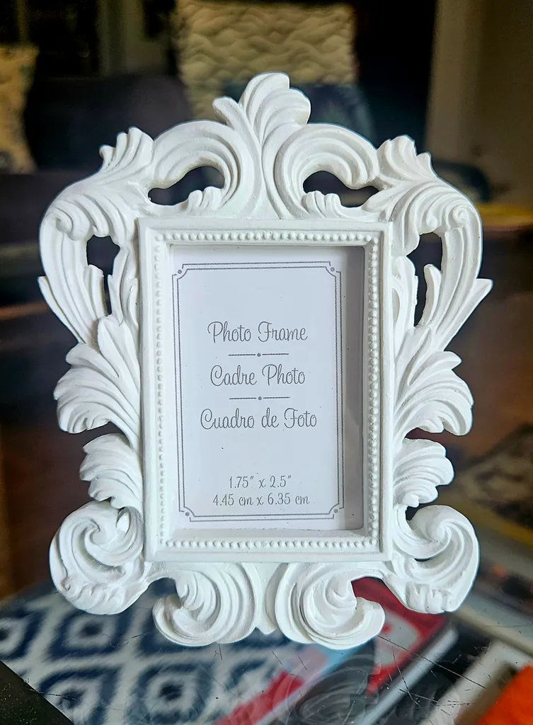 Small white photo frame.  Ornate design.  Holds a small photo.   photo 1