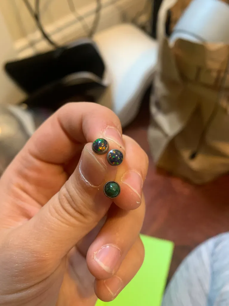 Three stud earrings, two of which match photo 1