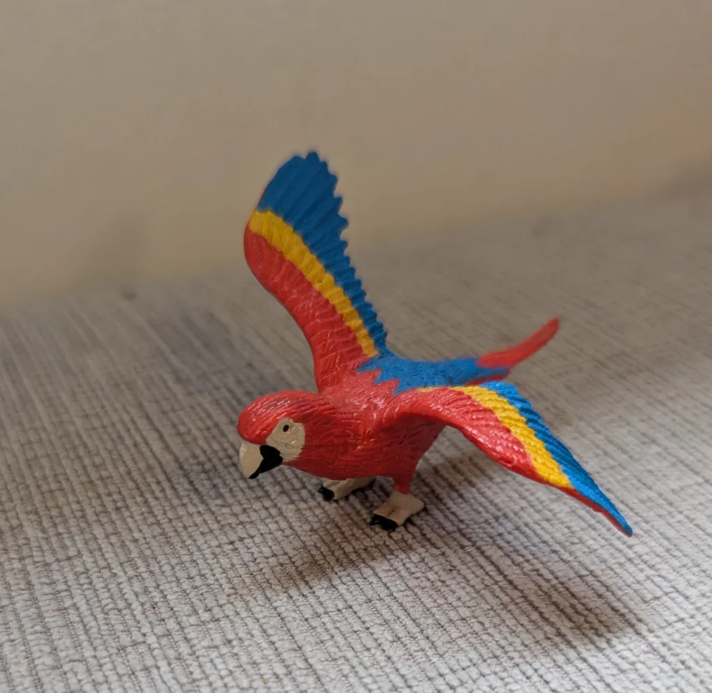 Red, Blue, and Yellow Plastic Parrot Toy photo 1