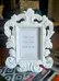 Small white photo frame.  Ornate design.  Holds a small photo.   photo 1