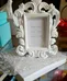 Small white photo frame.  Ornate design.  Holds a small photo.   photo 4